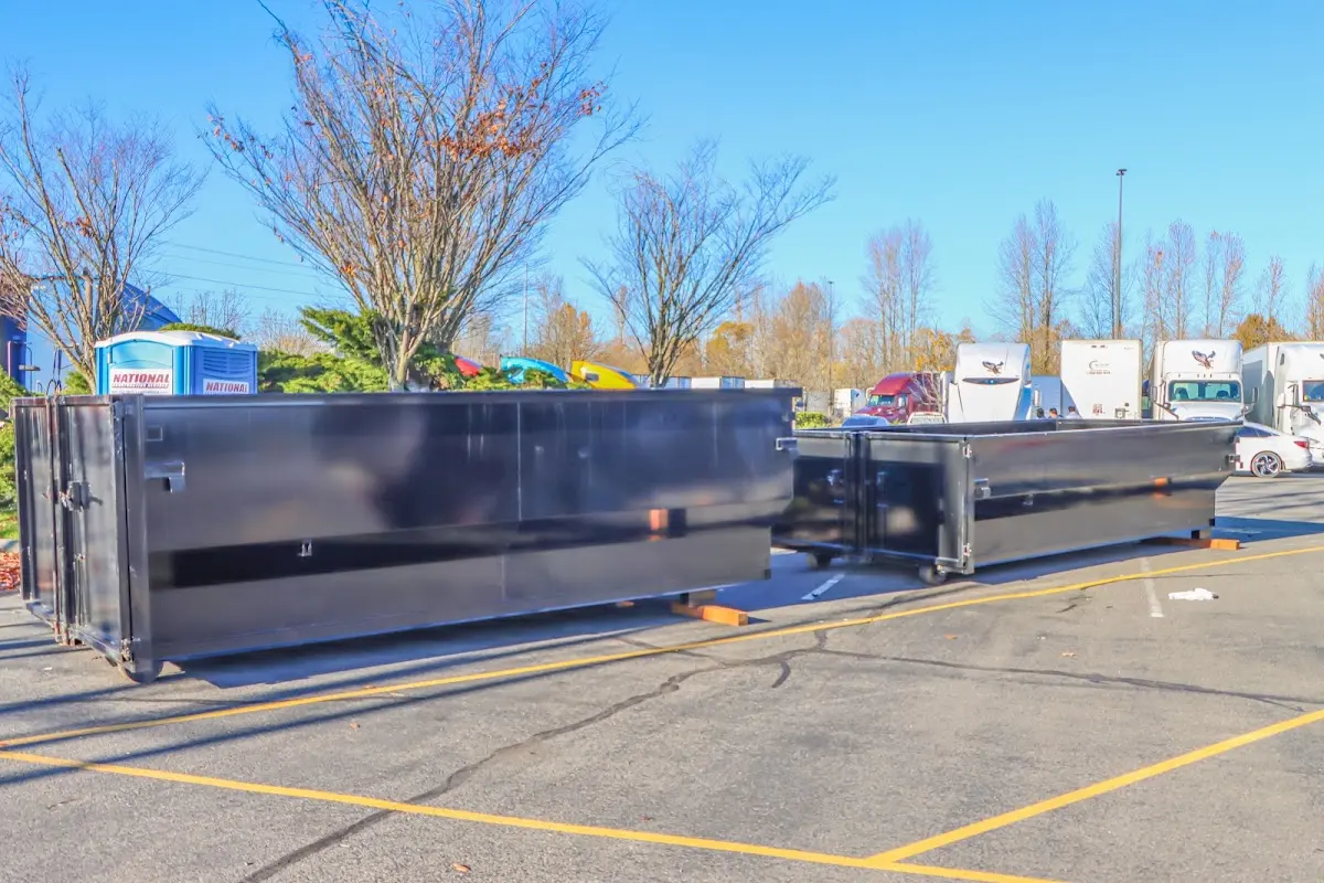Professional dumpster rental service with roll-off container on residential driveway in Marlborough